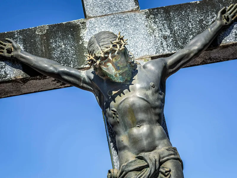 The central crucifix of Recoleta Cemetery against a blue sky